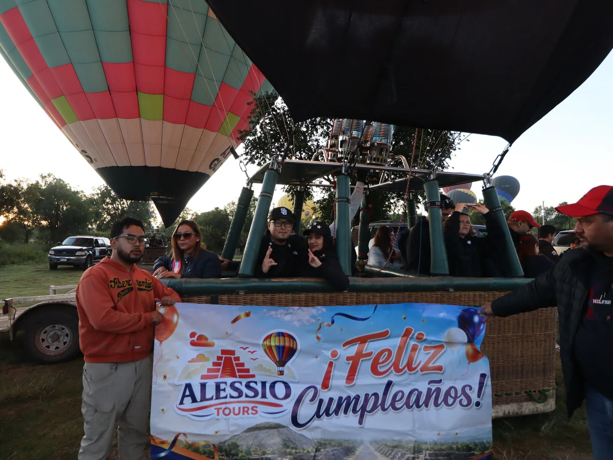 Pasajeros celebrando un cumpleaños junto al globo con una manta de Alessio Tours